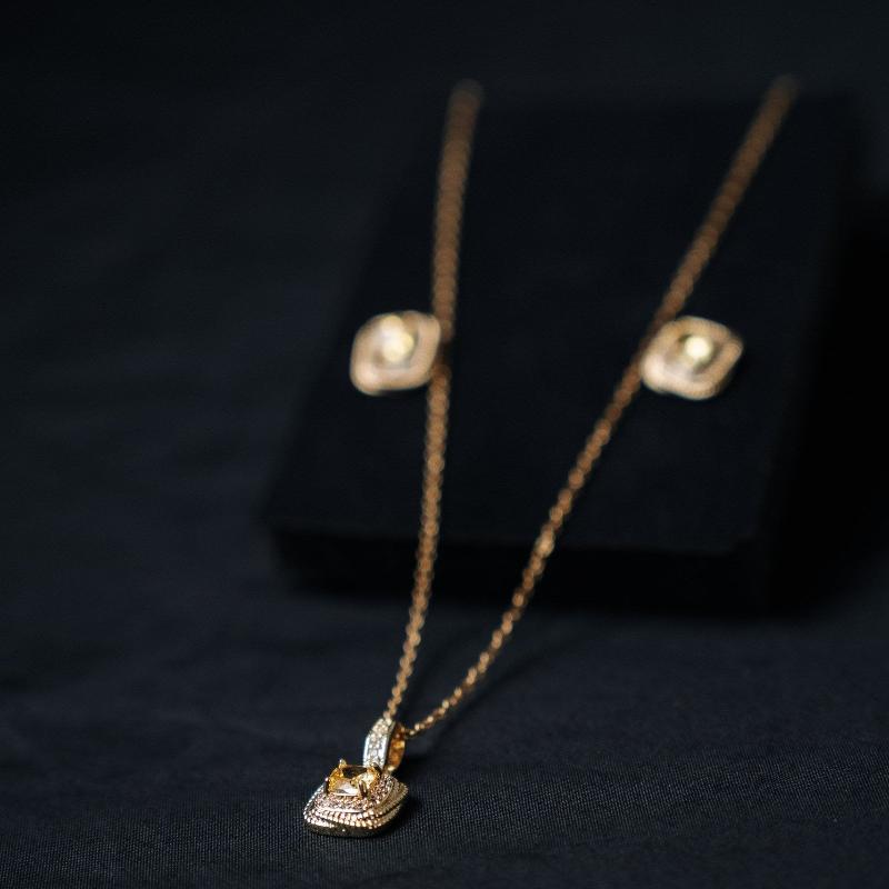 Gold Colored Necklace and Earrings Set with Spiral Texture and Yellow Stone